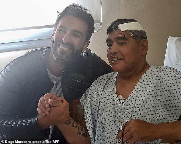 Diego Maradona allegedly died surrounded by the smell of 'urine and faeces', a lawyer representing his daughters has claimed (pictured: Maradona with his doctor Leopoldo Luque)