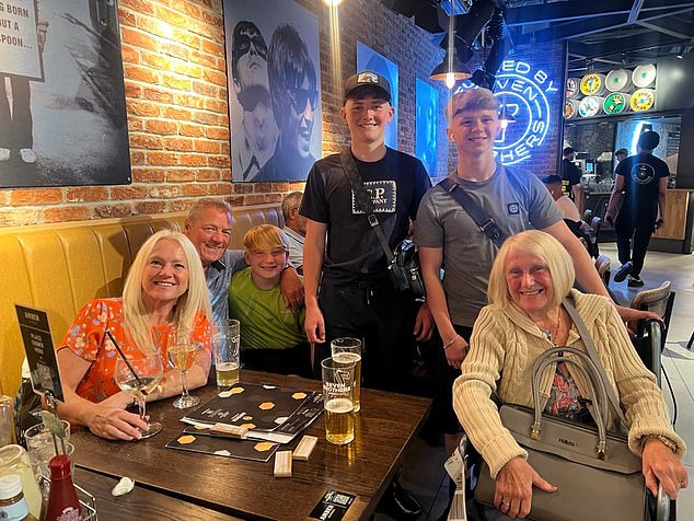 A disabled grandmother has accused sunbed vigilantes of ruining her family's holiday after they hid their pool-side towels. Pictured: Wheelchair user Elaine Simpson (R) with her family