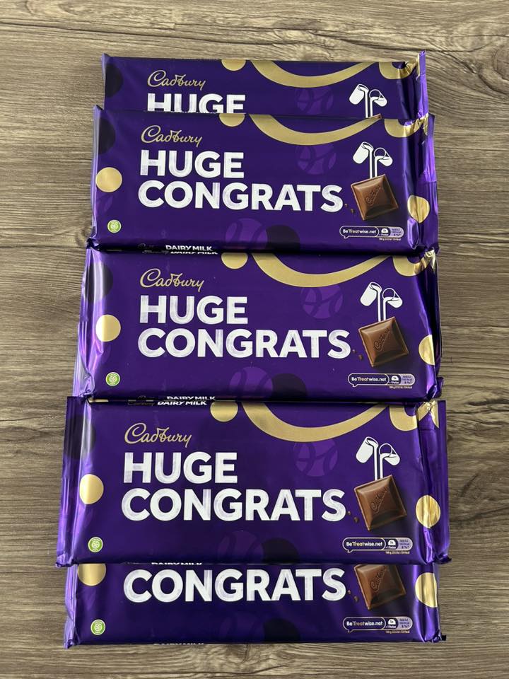 Stack of discontinued Cadbury Huge Congrats chocolate bars.