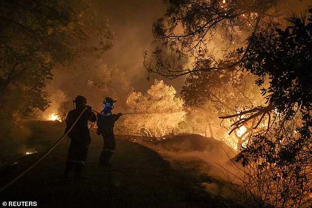 Firefighters try to tackle a wildfire burning on Chios island, Greece, June 23, 2025