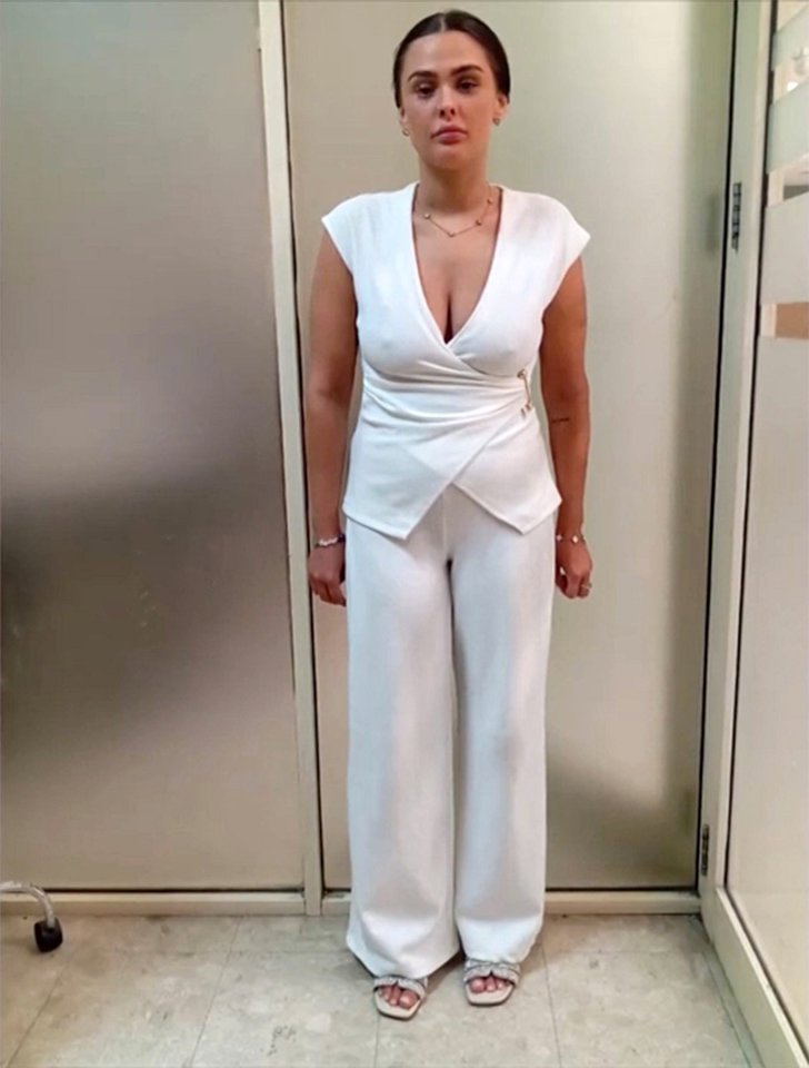 Woman in white pantsuit.
