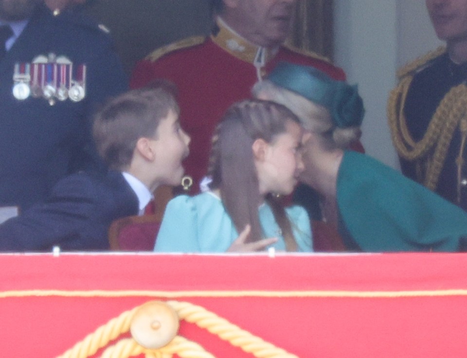 Prince Louis and Princess Charlotte on a balcony.