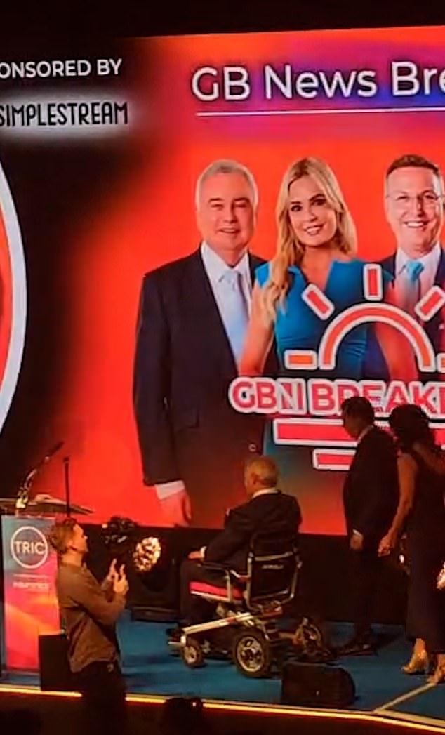 The TV presenter, 65, entered the stage via a wheelchair ramp before he accepted the gong on behalf of the team