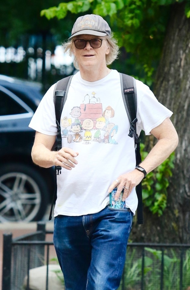 Eric Stoltz wearing a Peanuts t-shirt and cap.