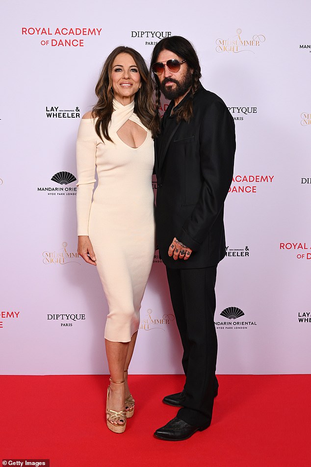 Elizabeth Hurley looked loved-up with her boyfriend Billy Ray Cyrus as they attended The Royal Academy of Dance fundraising evening on Monday