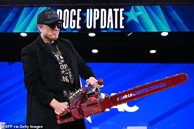 Elon Musk holds a chainsaw reading 'long live freedom, damn it!' at the Conservative Political Action Conference in February
