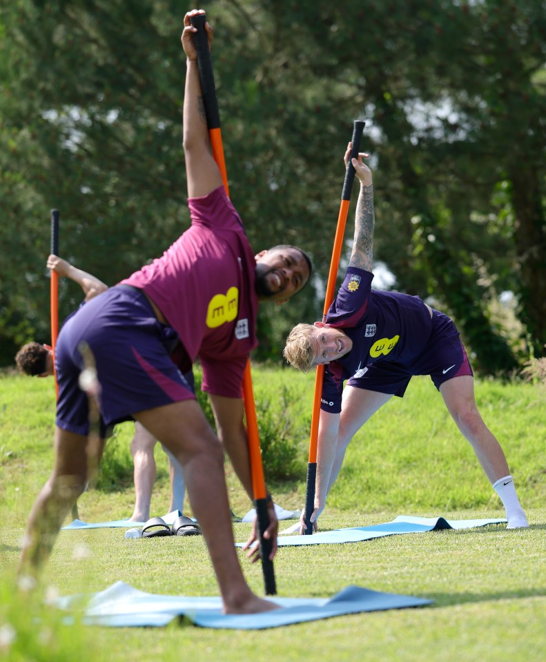 England soccer players stretching with long poles.