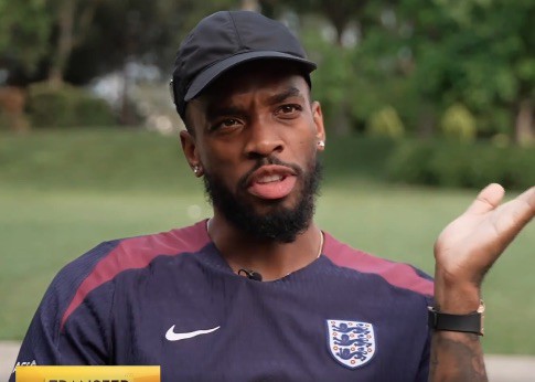 Man in England jersey speaking.