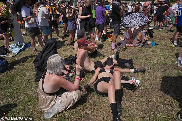 Festivalgoers relax in the sun at the West Holts stage during the Glastonbury Festival at Worthy Far