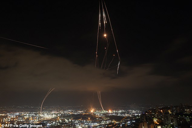 Israeli air defence systems are activated to intercept Iranian missiles over the Israeli city of Haifa amid a fresh barrage of Iranian rockets on June 16, 2025