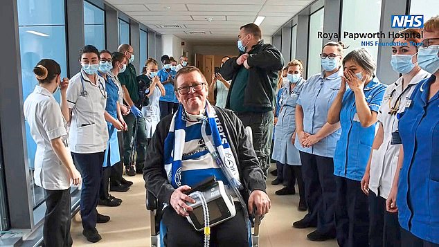 Steve Carr, 67, had the neurodegenerative condition motor neurone disease. Pictured: Steve surrounded by NHS nurses