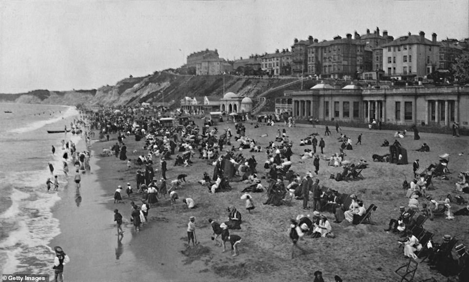 This image, which dates from around 1910, shows holidaymakers enjoying the beach at Bournemouth's West Sands. Visit Bournemouth explains that the arrival of the railways led to a massive growth in the number of summer visitors to the town