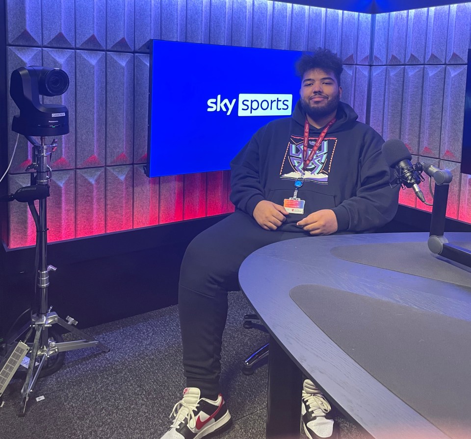 Person sitting in a Sky Sports studio.