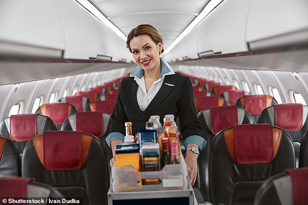 The arrival of the drinks trolley is usually a highlight of a long-haul flight (stock photo)