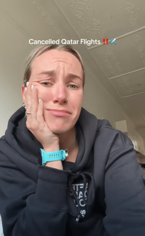 Upset woman reacting to cancelled Qatar flights.