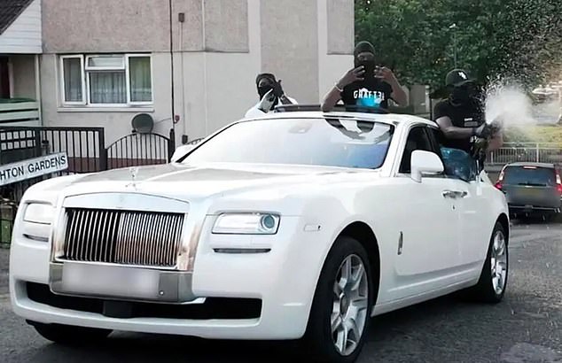 Twelve drug dealers who sprayed Dom Perignon from a white Rolls-Royce in a drill rap video to boast about their weapons and wealth have been jailed for 130 years