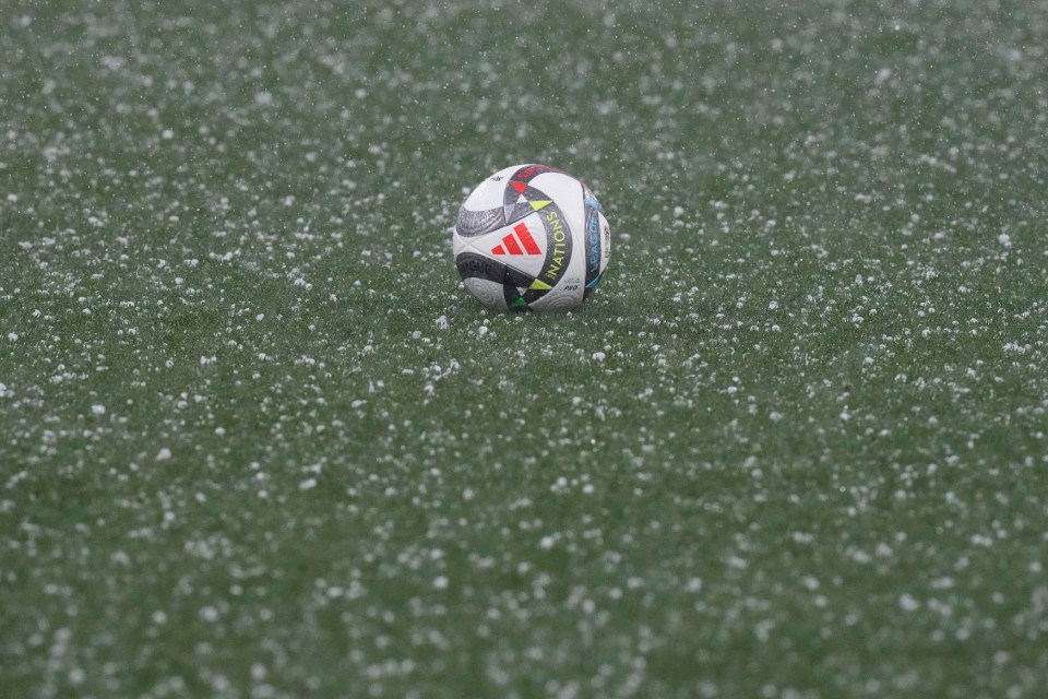 Hail covers the pitch during a storm before the Nations League semifinal soccer match between Portugal and Germany at the Munich Football Arena, in Munich, Germany, Wednesday, June 4, 2025. (AP Photo/Matthias Schrader)