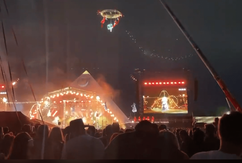 Aerial performers above a concert crowd.