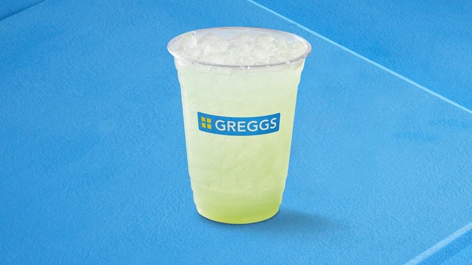 A Greggs iced drink in a clear plastic cup.