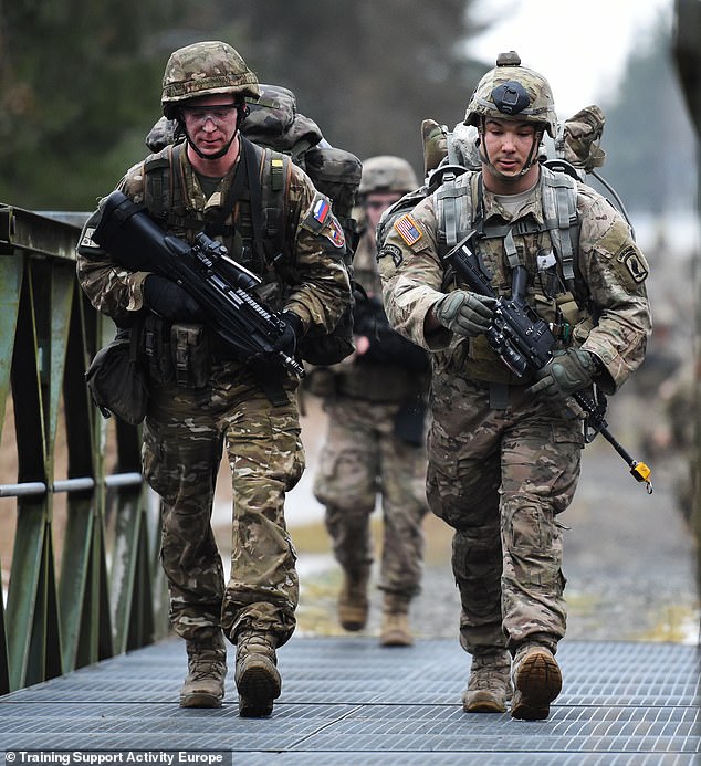 Army paratrooper Travis Decker, right, assigned to 2nd Battalion, 503rd Infantry Regiment, is pictured in 2016 during the 173rd Airborne Brigade's Expert Infantryman Badge testing phase at the 7th Army Joint Multinational Training Command’s Grafenwoehr Training Area in Germany