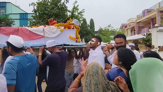 British national Vishwash Kumar Ramesh, 40, from Leicester, had plasters on his face and was walking with a limp as he held up the casket of his sibling Ajay