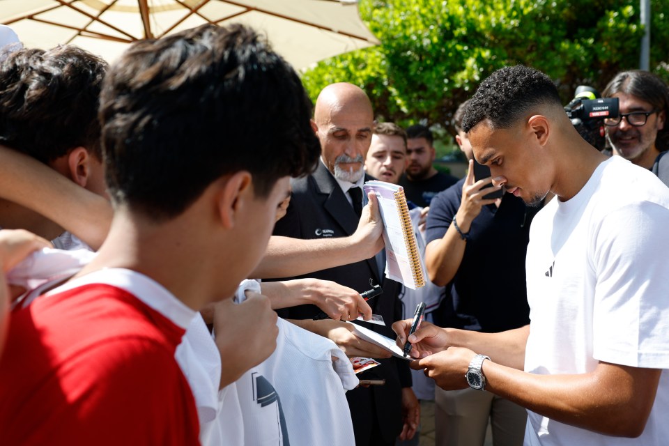 Trent Alexander-Arnold signing autographs for fans.