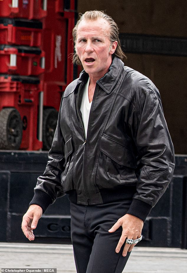 A Hollywood legend looked completely unrecognisable on the set of his new NFL movie this week - but can YOU guess who it is?