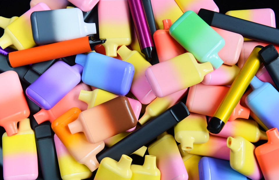 Pile of colorful disposable vapes.