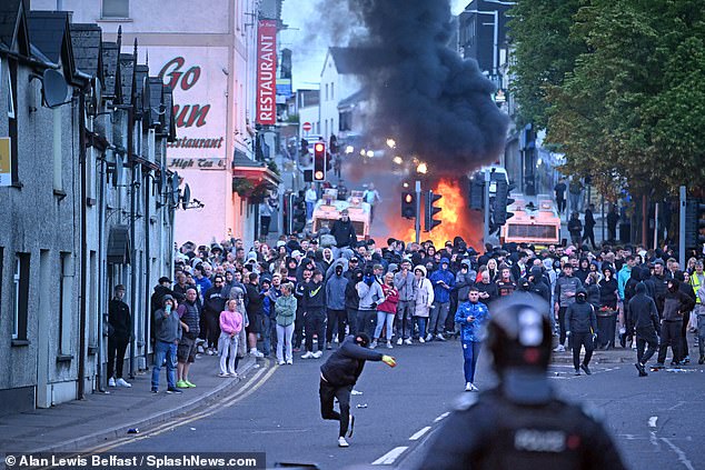 Racially motivated rioters set fire to property and launched fireworks and missiles at police lines
