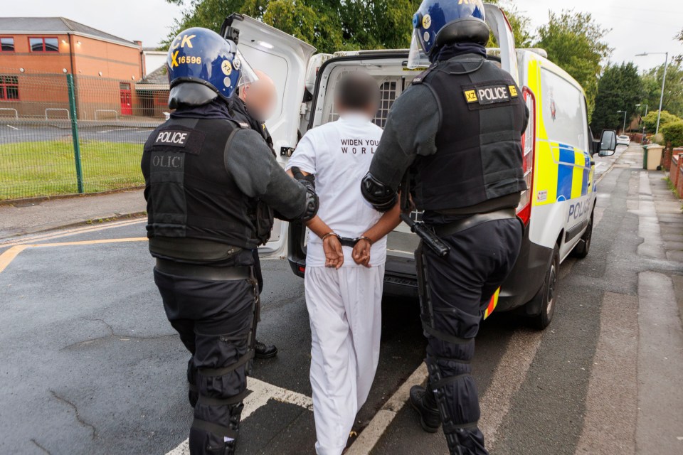 Police officers arresting a person.
