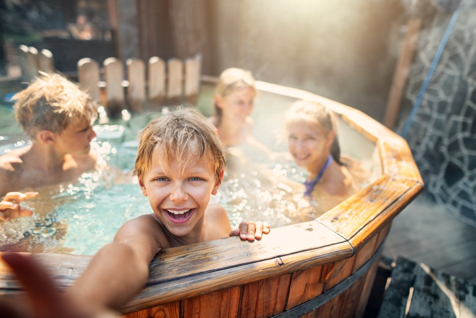 Children enjoying a wood-fired hot tub.