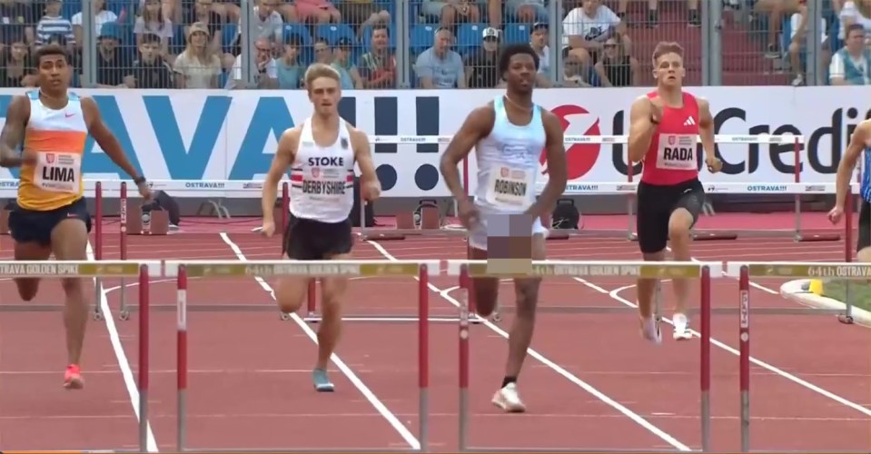 Four hurdlers racing on a track.