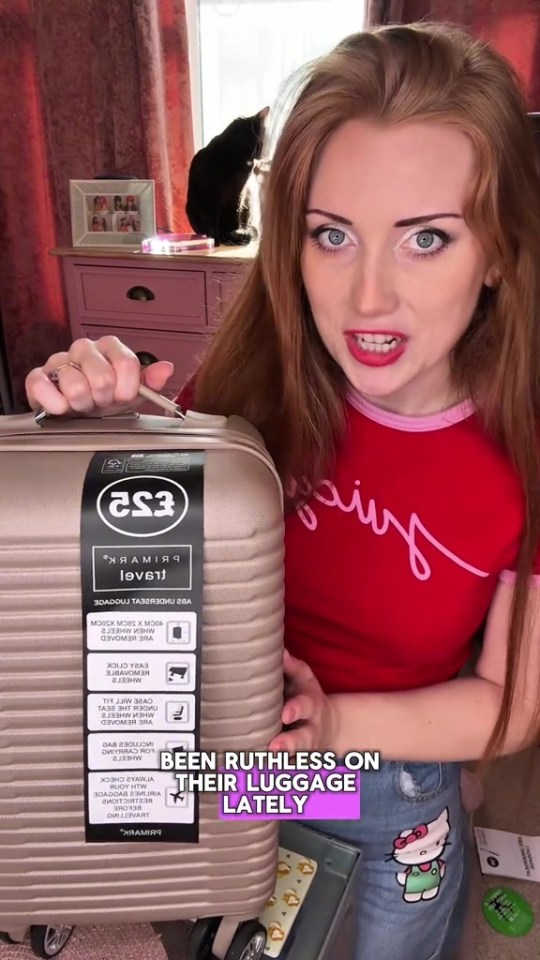 Woman showing a Primark cabin bag.