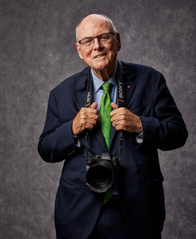 Portrait of Arthur Edwards, a royal photographer, holding a Sony camera.