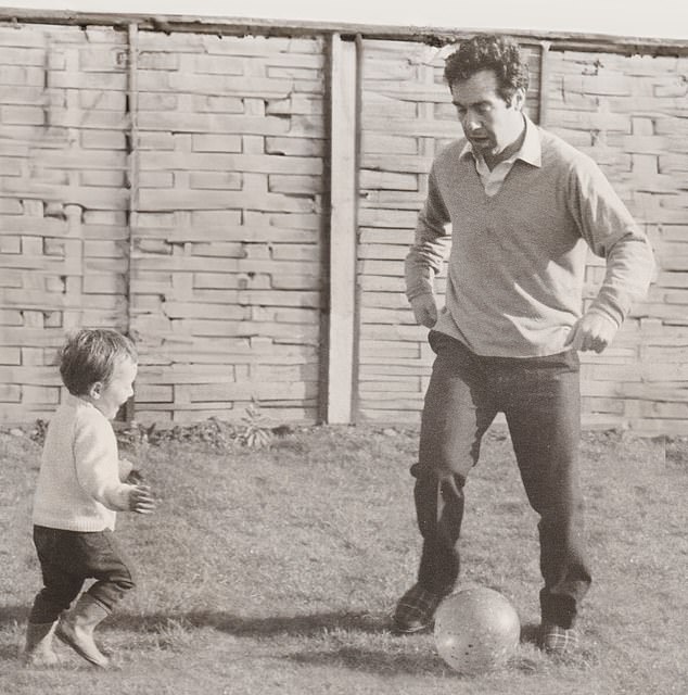 Rob aged around three-years-old playing with his father Robin