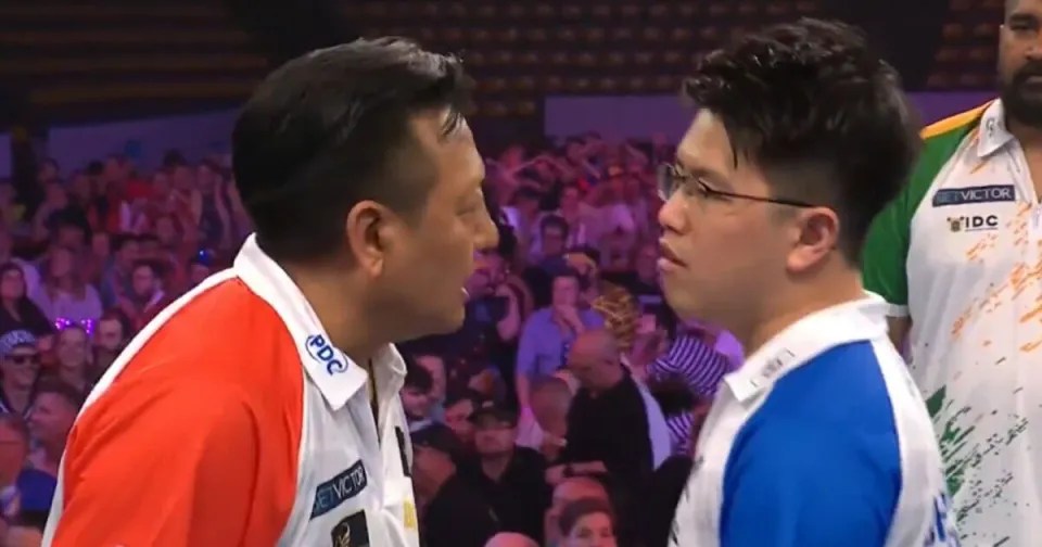Two darts players facing each other before a match.