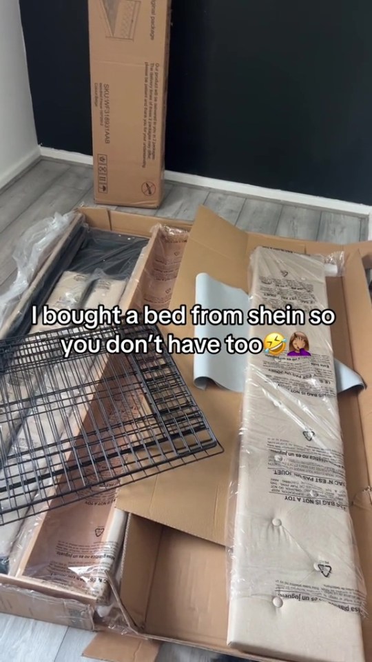 Disassembled bed frame parts in boxes.