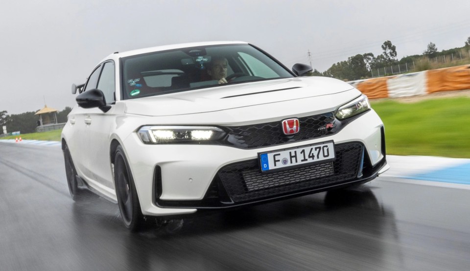 White Honda Civic Type R driving on a racetrack.