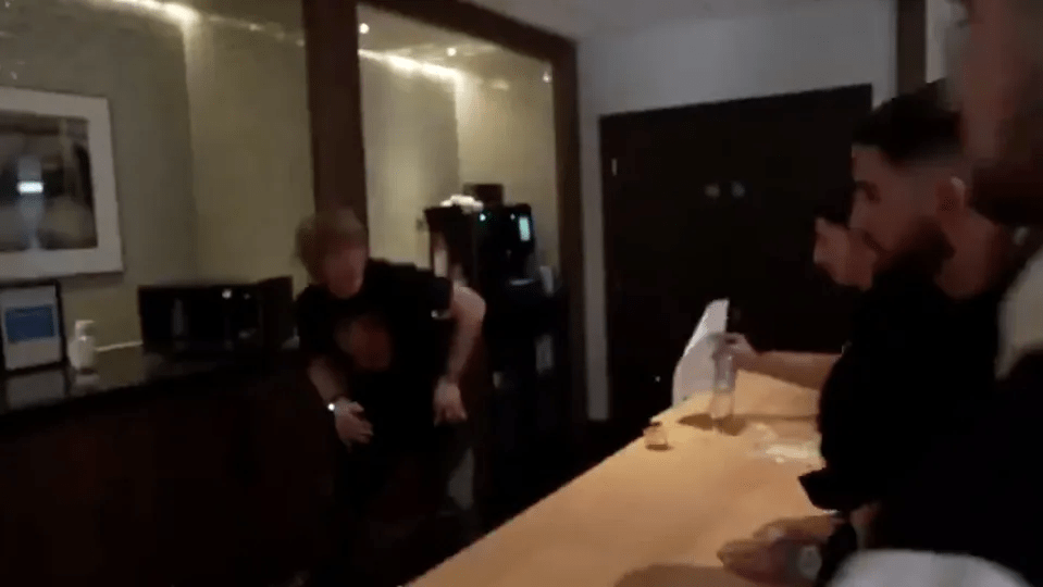 People at a counter in a hotel.