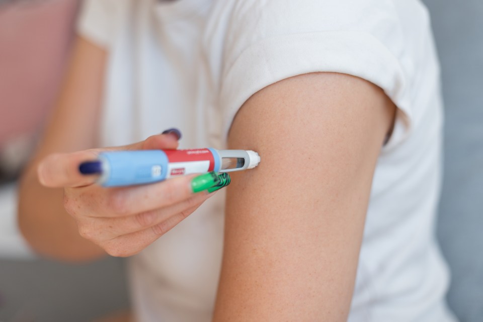 Woman injecting Ozempic.