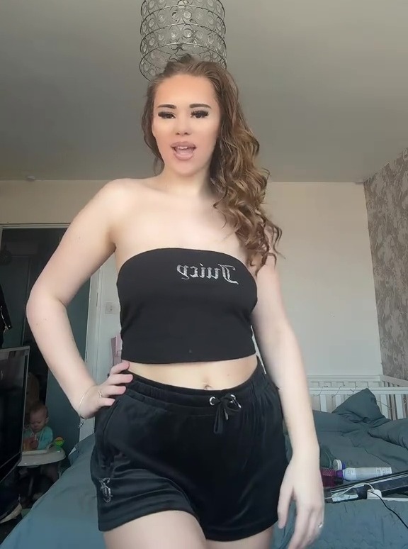 Woman in black Juicy Couture top and shorts.