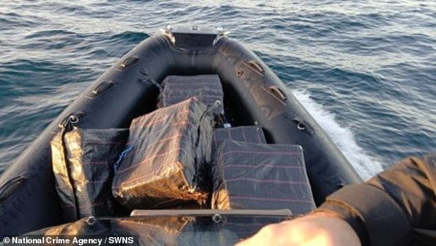 A boat filled with £18million worth of cocaine crashed into a beach after three men were chased for 28 miles at sea by 'Britain's FBI '