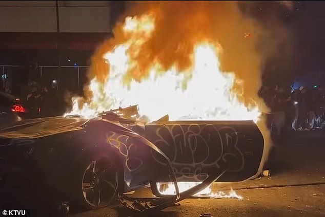 The streets of Oakland descended into Mad Max-style destruction as illegal street car 'sideshows' unfolded across the city in the early hours of Sunday night