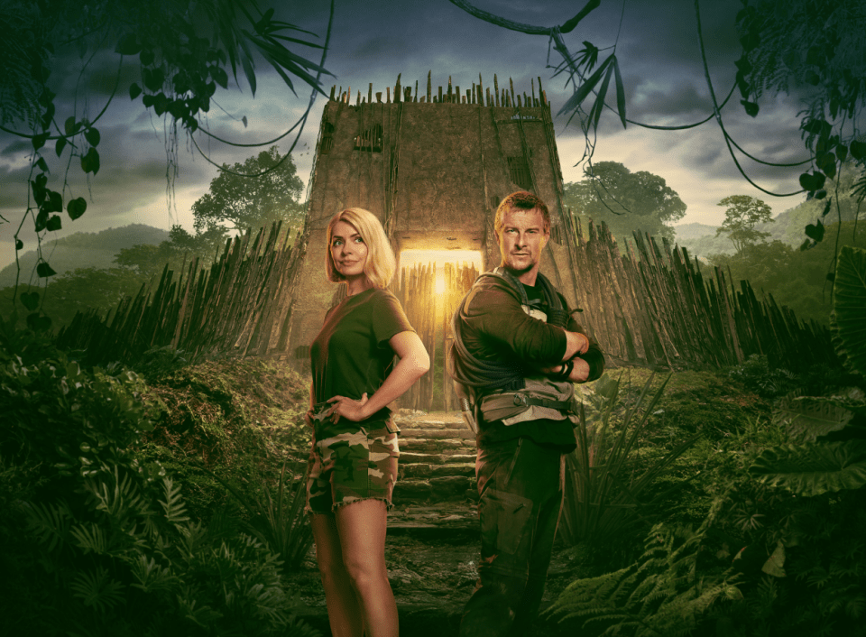 Promotional image of a man and woman standing in front of a jungle structure.