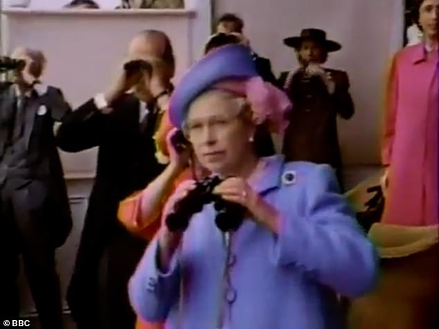 Dressed in the a bright purple ensemble, the Queen had begun to watch the race of a screen before running through the room with binoculars in hand to watch the three-year-old stallion get over the line from the balcony