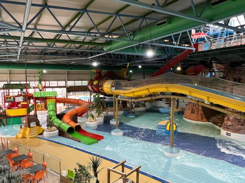 Indoor water park with slides and play structures.