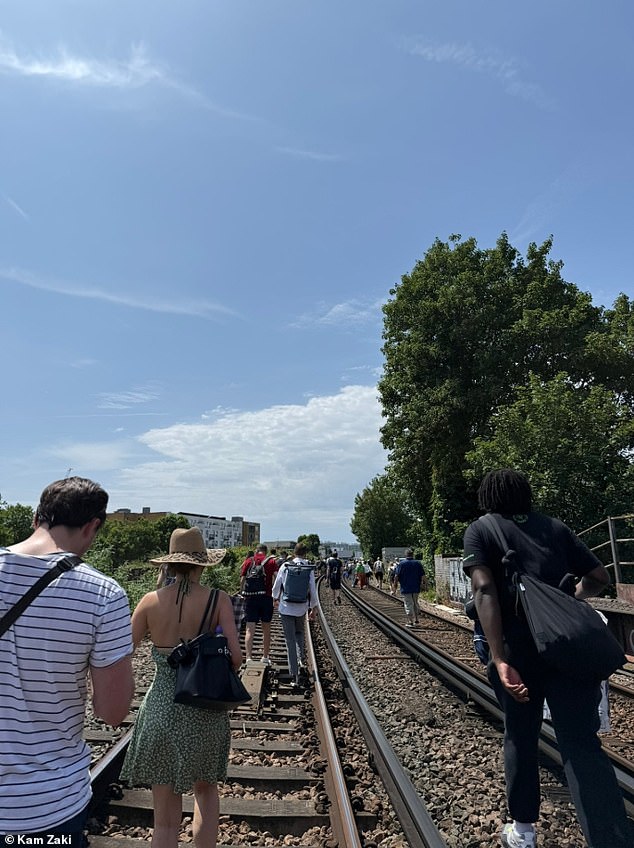 Kam Zaki, 47, is one of the 1,800 passengers who were stranded on the Thameslink services which had them feeling like they were being 'slow cooked' in 'an oven' (Picture taken by Mr Zaki on the track)