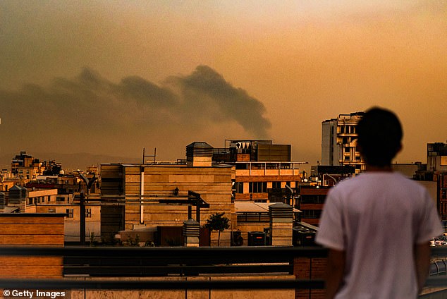 A general view of Tehran covered in smoke and dust following explosions after an Israeli airstrike, on June 15, 2025