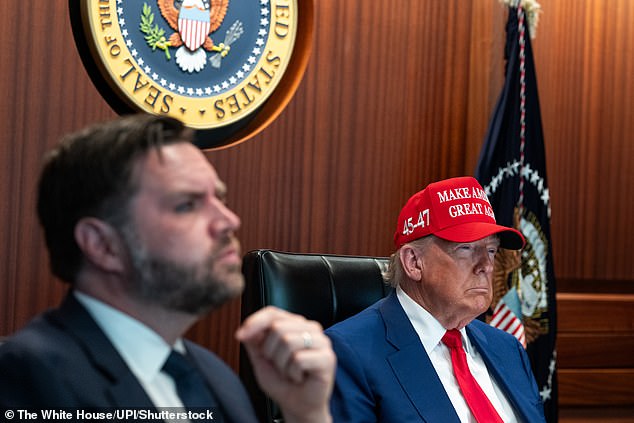 The Kremlin last night accused the United States of opening a Pandora's box with its strikes on Iran's nuclear facilities, warning it was gambling with the 'safety and well-being of humanity as a whole'. Pictured: Donald Trump wears a MAGA cap as he sits in the Situation Room of the White House