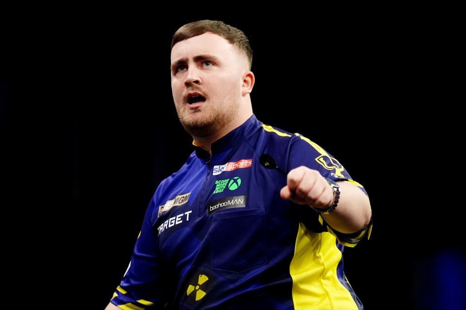 Luke Littler playing darts.
